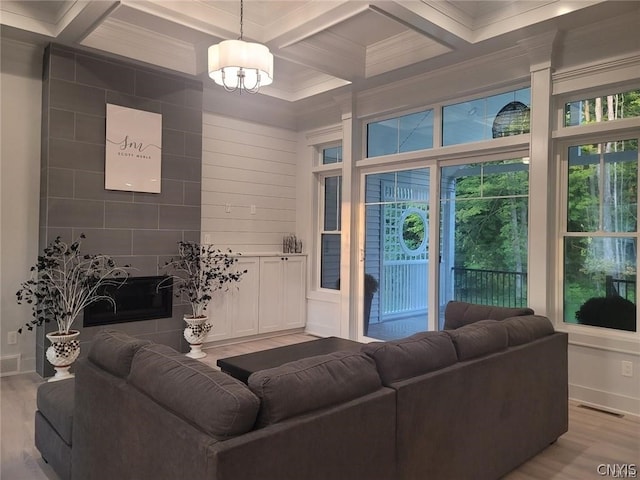 living room with crown molding, light hardwood / wood-style floors, coffered ceiling, and beamed ceiling