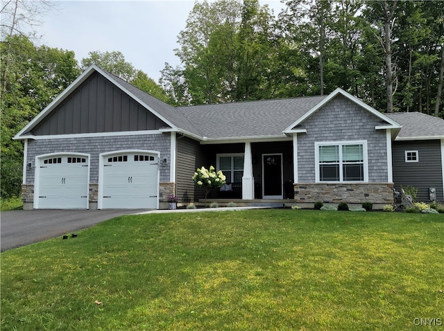 craftsman-style house featuring a garage and a front lawn