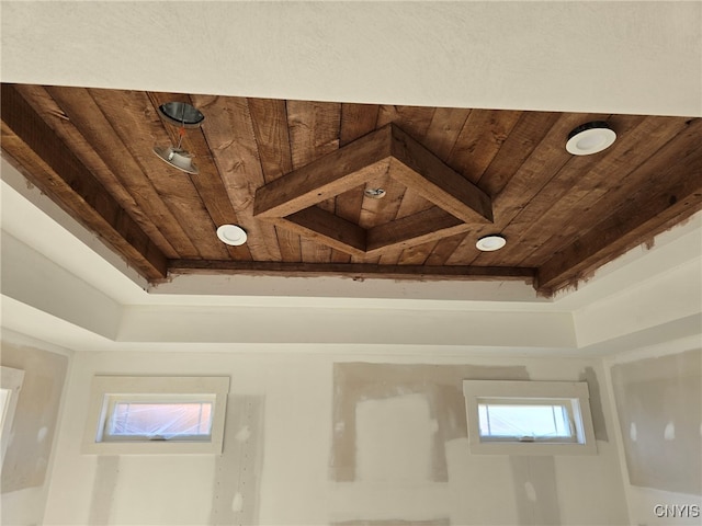 room details with a tray ceiling and wooden ceiling