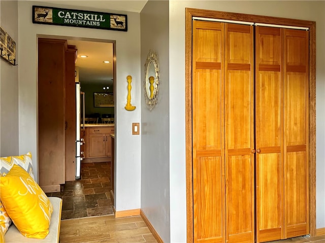 corridor with dark hardwood / wood-style floors