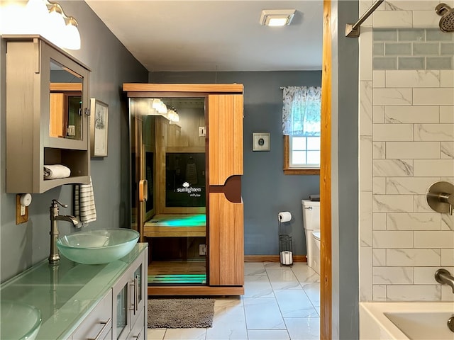 full bathroom featuring  shower combination, vanity, and toilet