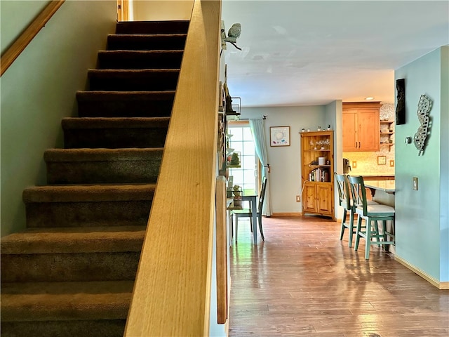 stairs featuring hardwood / wood-style floors