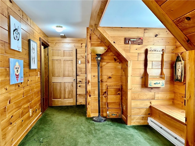 interior space with beamed ceiling, a baseboard radiator, wooden walls, and dark colored carpet