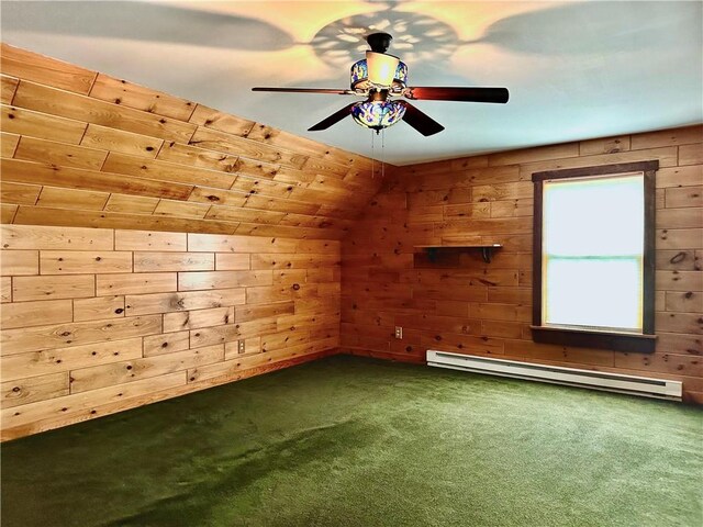 bonus room with ceiling fan, baseboard heating, wood walls, and dark carpet