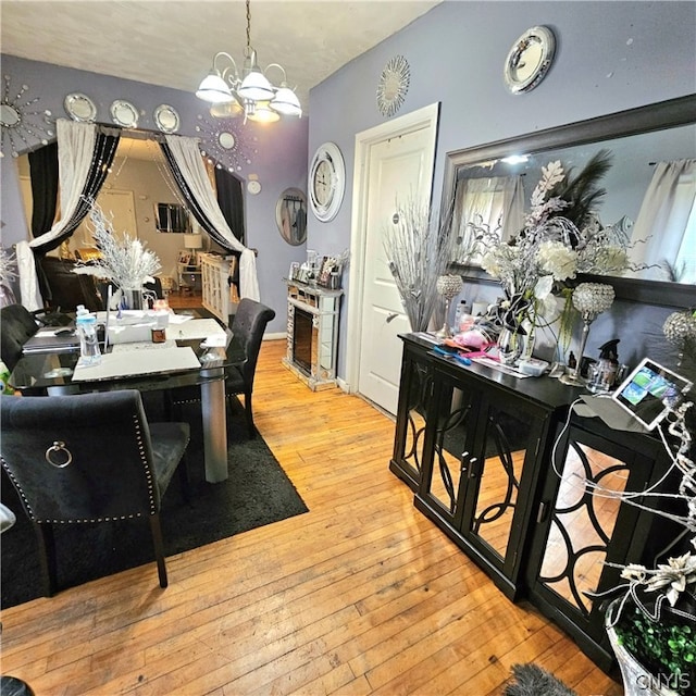 dining area featuring light hardwood / wood-style floors and a chandelier