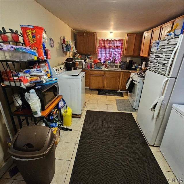 kitchen featuring light tile patterned floors and white appliances