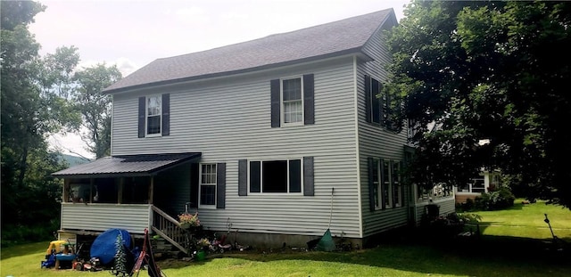 back of property featuring a lawn