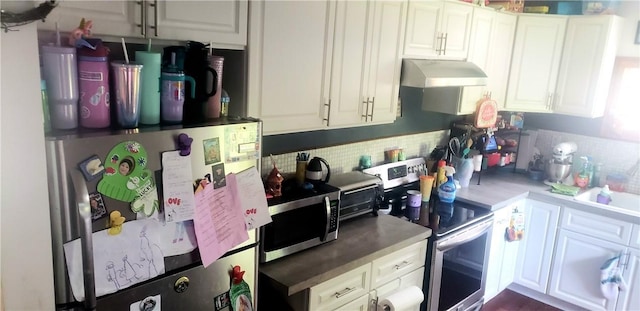 kitchen featuring white cabinetry, stainless steel appliances, and decorative backsplash
