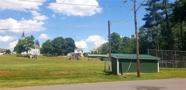 surrounding community featuring a playground and a yard