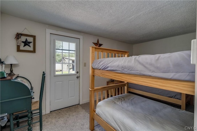 carpeted bedroom featuring a textured ceiling