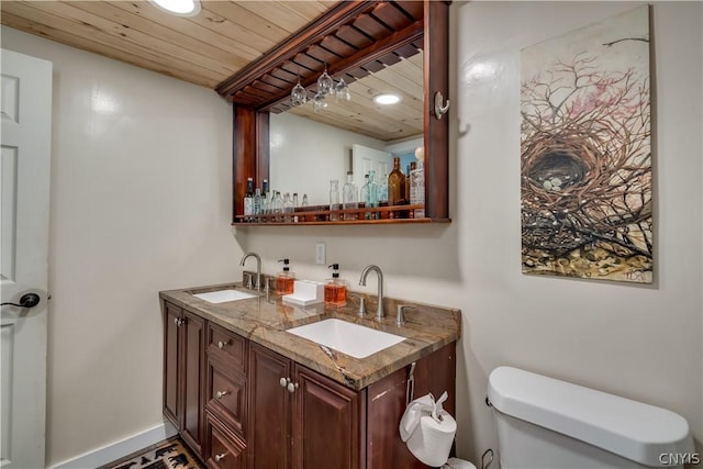 bathroom with wood ceiling, vanity, and toilet