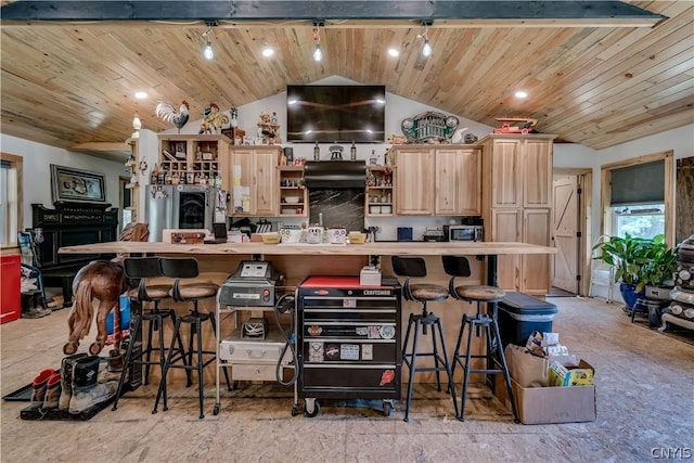 kitchen featuring lofted ceiling, wood ceiling, a breakfast bar, and light brown cabinets