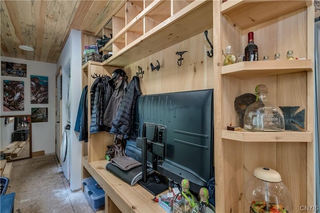 mudroom featuring wooden walls and wooden ceiling