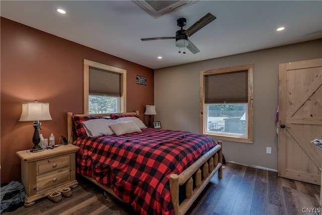 bedroom with dark hardwood / wood-style floors and ceiling fan