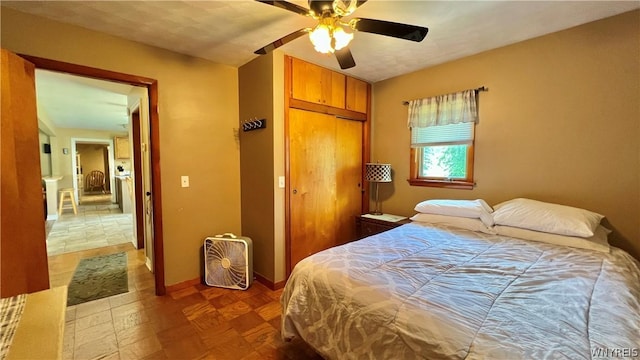 bedroom with ceiling fan and a closet