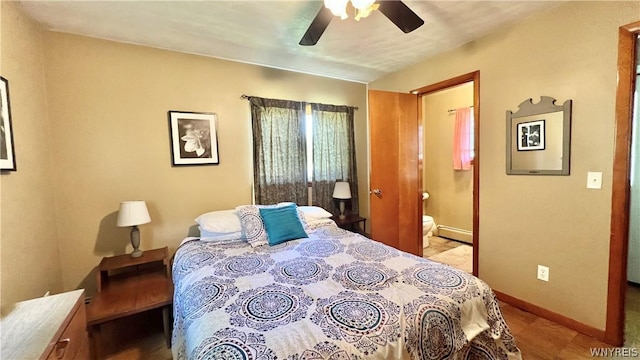 bedroom featuring ensuite bathroom, baseboard heating, and ceiling fan