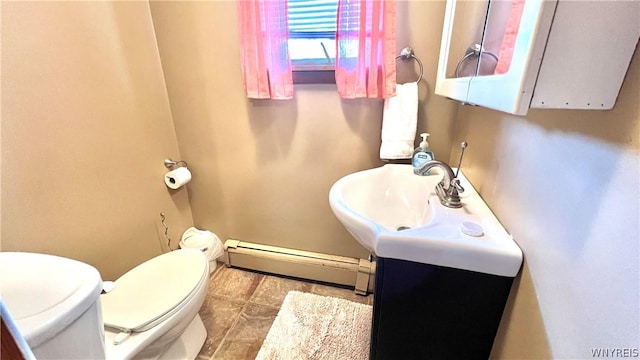 bathroom with vanity, a baseboard radiator, and toilet