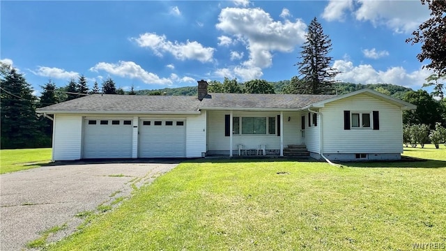 ranch-style house with a garage and a front lawn