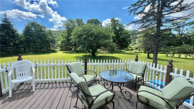 deck with a lawn and a water view