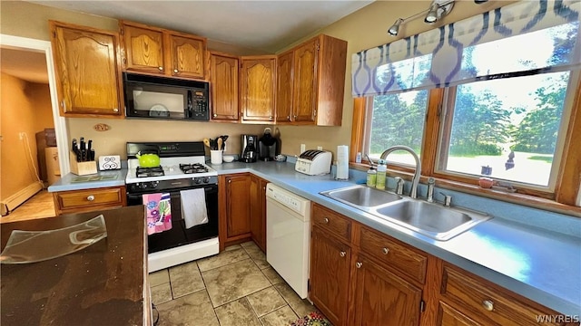 kitchen with light tile patterned flooring, white appliances, and sink