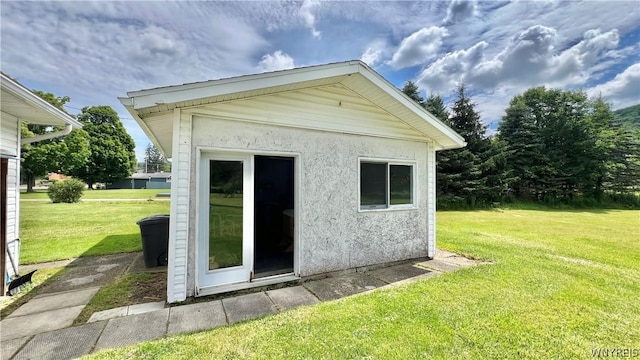 view of outbuilding with a yard