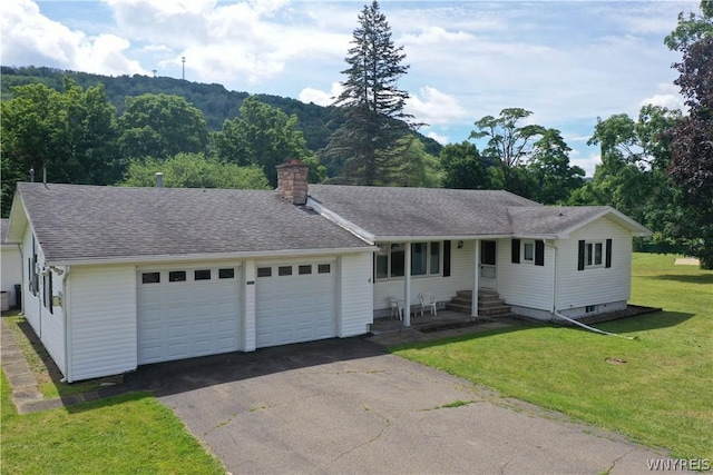 single story home with a front yard and a garage