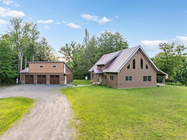 view of front of house with a garage, a front lawn, and an outdoor structure