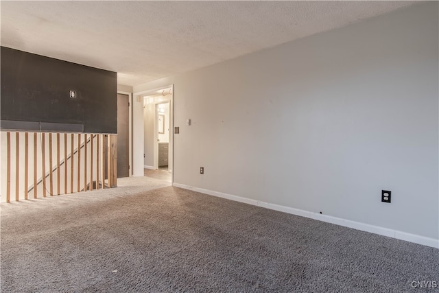 carpeted spare room with a textured ceiling