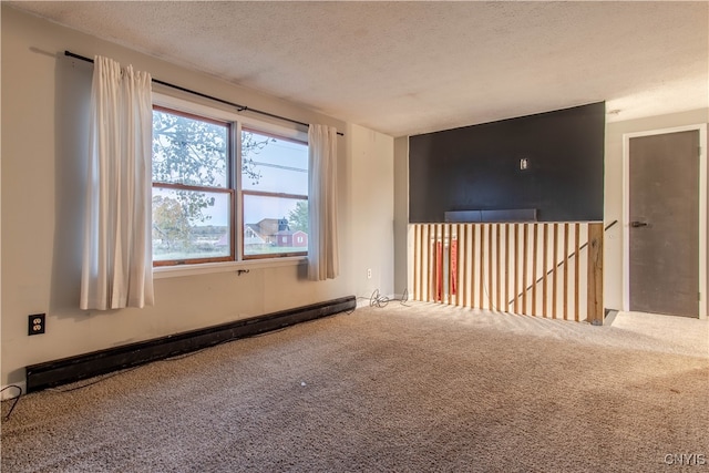 empty room featuring a baseboard radiator, a textured ceiling, and carpet floors