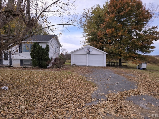 view of side of home with an outdoor structure and a garage