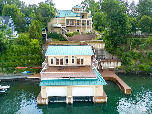 rear view of property with a deck with water view