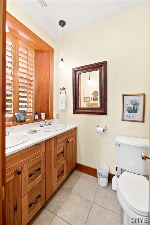 bathroom with vanity, tile patterned floors, and toilet