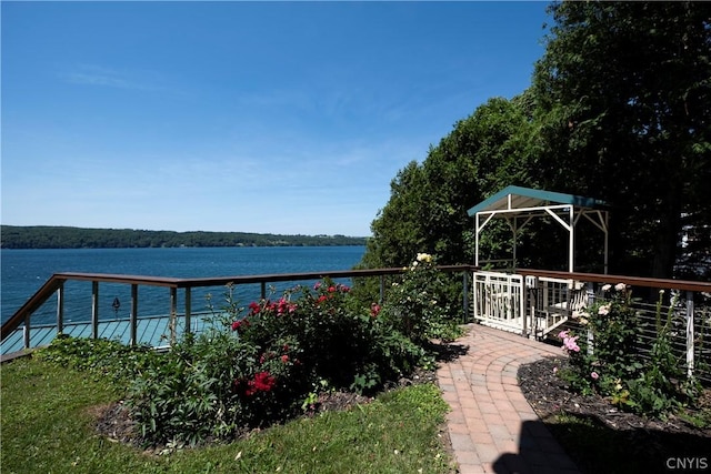 view of patio with a deck with water view