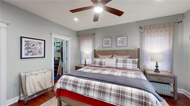 bedroom with multiple windows, a closet, ceiling fan, and dark hardwood / wood-style floors