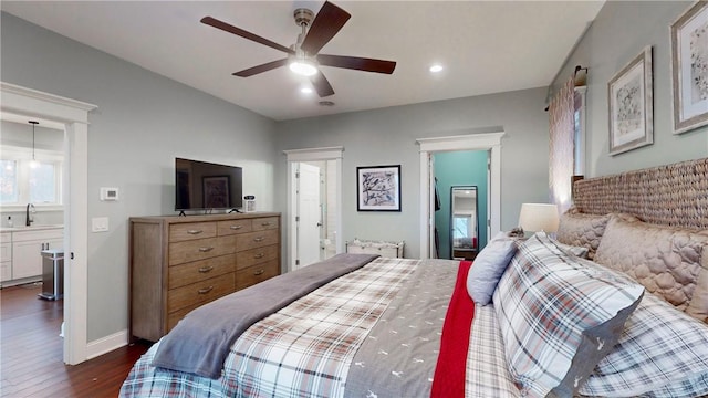 bedroom featuring ceiling fan, sink, connected bathroom, and dark wood-type flooring