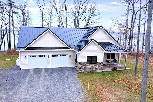 view of front facade with a porch, a garage, and a front lawn