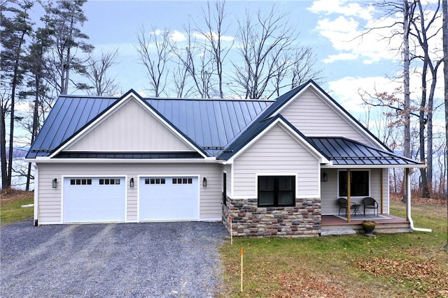 view of front facade with a porch, a garage, and a front lawn