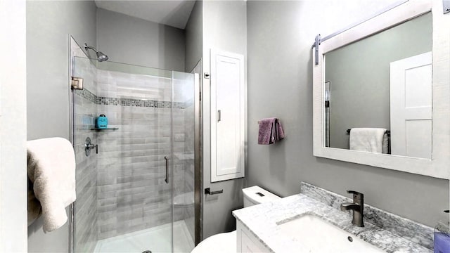 bathroom featuring vanity, toilet, and walk in shower