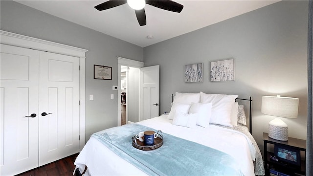 bedroom featuring a closet, dark hardwood / wood-style floors, and ceiling fan