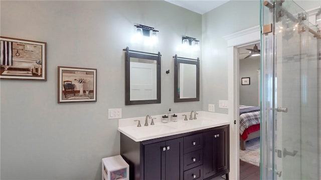 bathroom with a shower, vanity, and ceiling fan