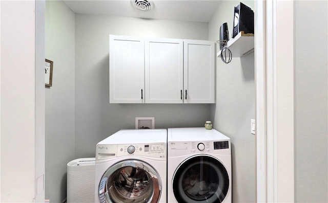 laundry area with cabinets and washer and dryer