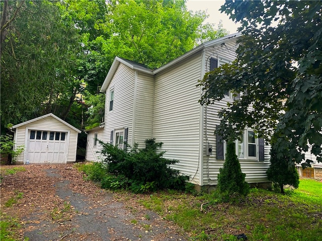 view of property exterior featuring a garage and an outdoor structure