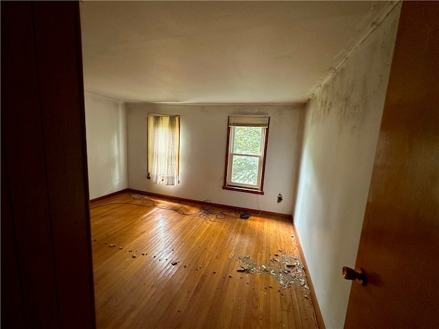 unfurnished room with hardwood / wood-style flooring