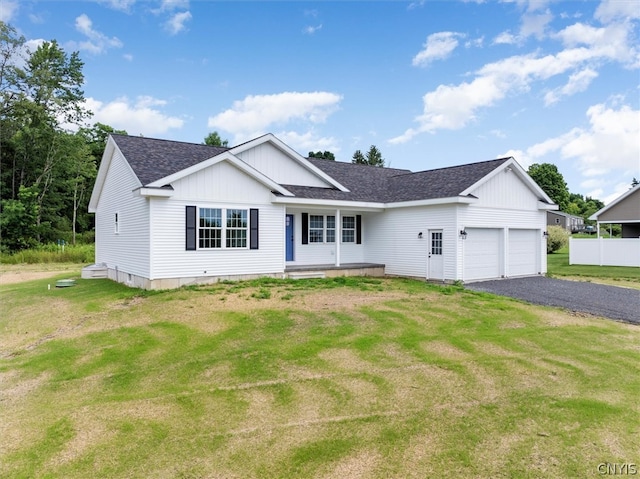 view of front of home with a garage and a front lawn