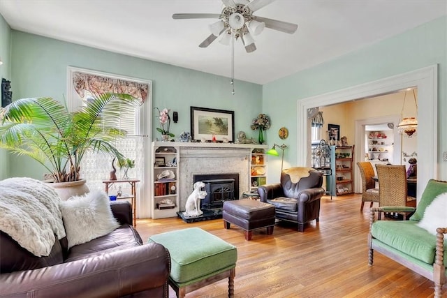 living room featuring ceiling fan and light hardwood / wood-style floors