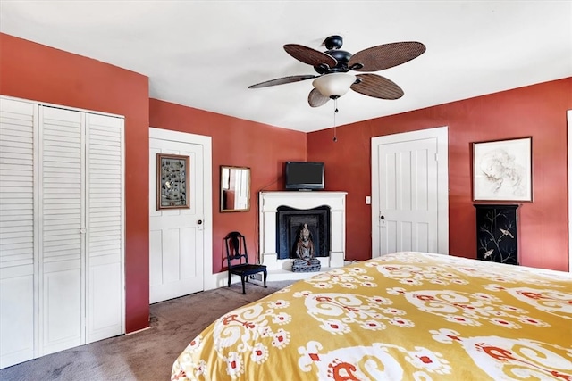 carpeted bedroom with a closet and ceiling fan