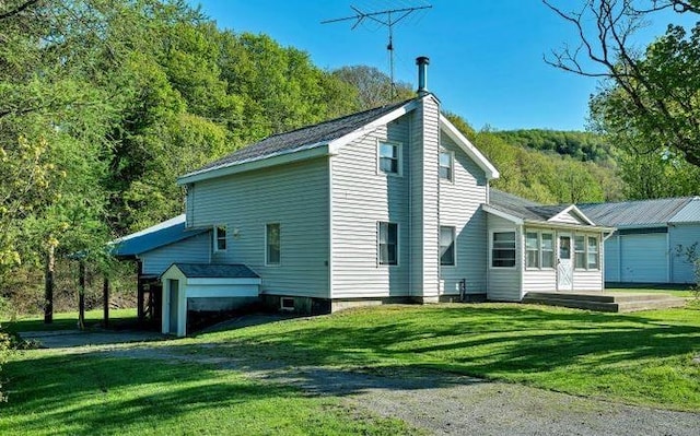 view of home's exterior with a yard