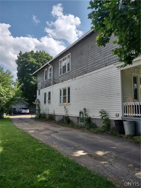 view of side of home with a yard