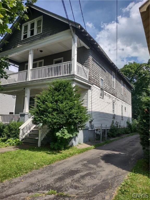 view of side of property with a balcony