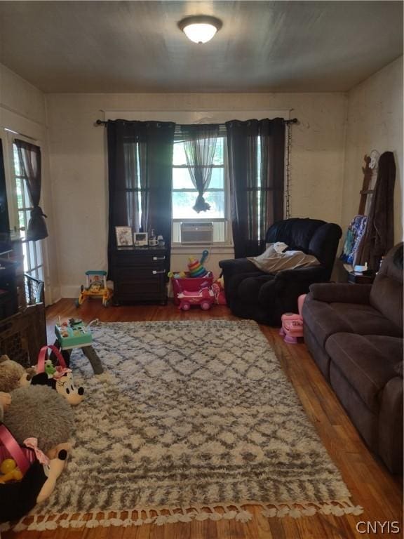 living room featuring wood-type flooring and cooling unit